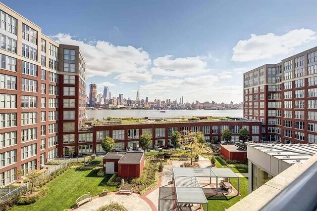 balcony with a water view and a city view