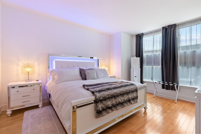 bedroom featuring baseboards and light wood-type flooring
