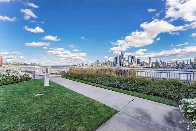 view of community featuring a lawn and a city view