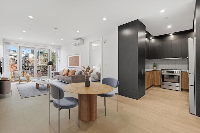 dining room with light wood-style floors, recessed lighting, and a wall mounted AC