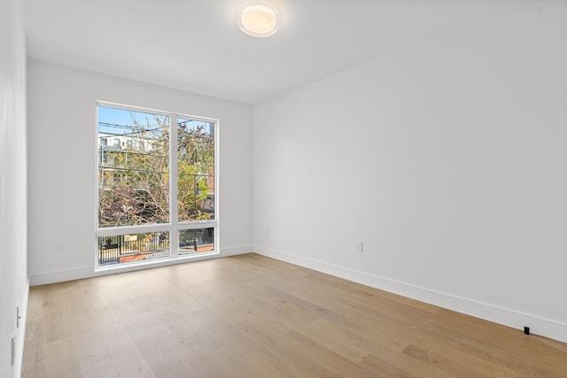 unfurnished room with light wood-type flooring