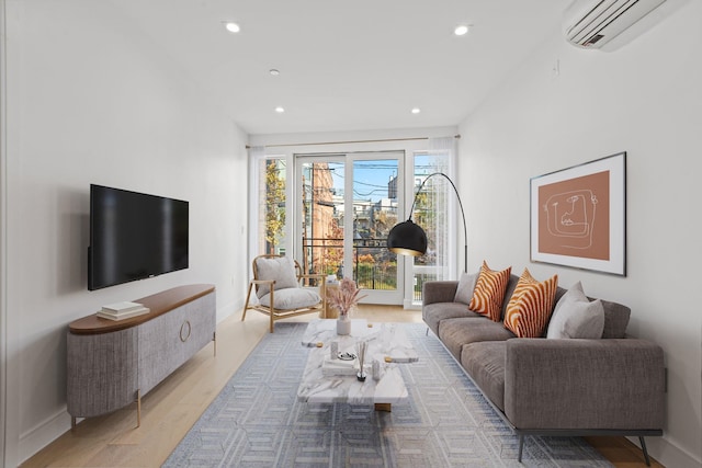 living area featuring recessed lighting, baseboards, wood finished floors, and a wall mounted AC