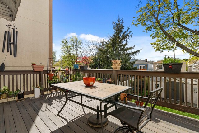 wooden terrace featuring outdoor dining space