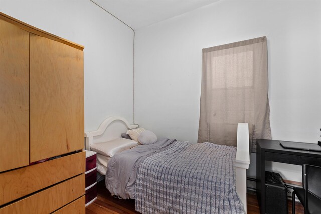 bedroom with dark wood finished floors