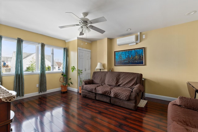 living room with a wall mounted air conditioner, wood finished floors, baseboards, ceiling fan, and recessed lighting