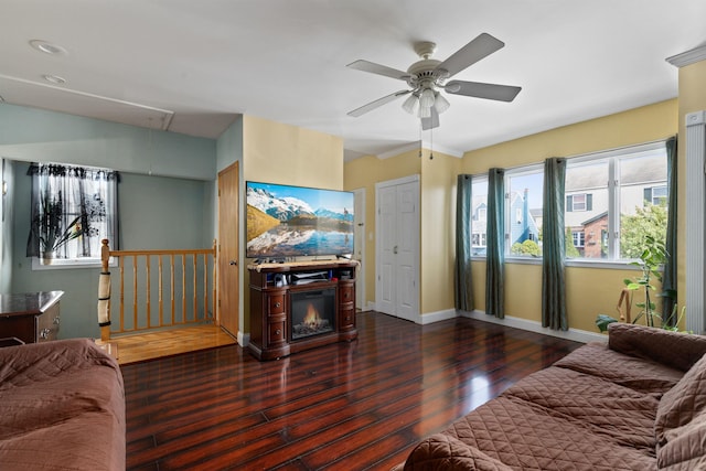 living area featuring attic access, wood finished floors, ceiling fan, and baseboards
