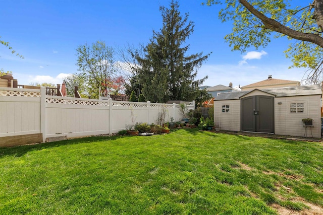 view of yard with a storage shed and an outbuilding