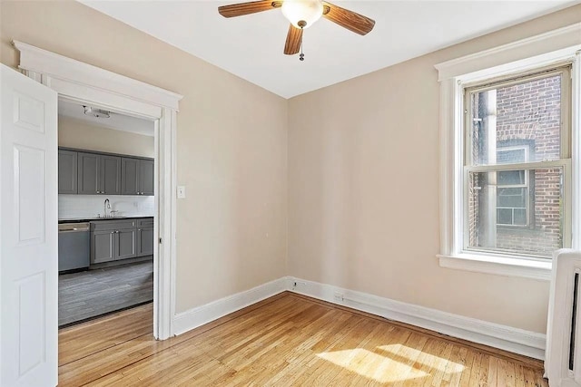 16 Belvidere Ave Unit 3F, Jersey City, NJ 07304 - unfurnished room with baseboards, light wood-style floors, a ceiling fan, and a sink