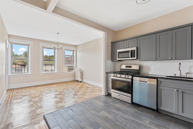 16 Belvidere Ave Unit 3F, Jersey City, NJ 07304 - kitchen with appliances with stainless steel finishes, a sink, gray cabinets, and radiator