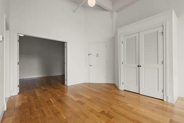 unfurnished bedroom featuring light wood-type flooring, ceiling fan, and baseboards