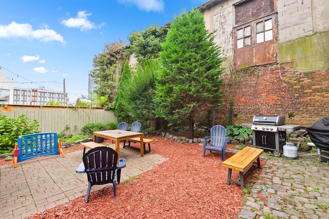 view of patio with grilling area and fence