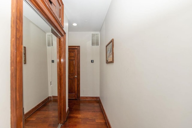 hall featuring visible vents, recessed lighting, baseboards, and wood finished floors
