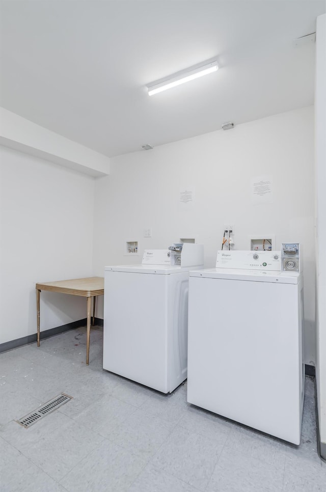 shared laundry area with baseboards, washing machine and clothes dryer, and visible vents