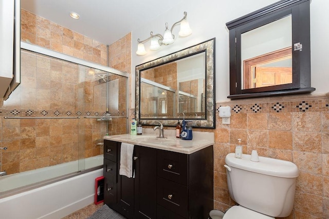 bathroom with vanity, combined bath / shower with glass door, and toilet