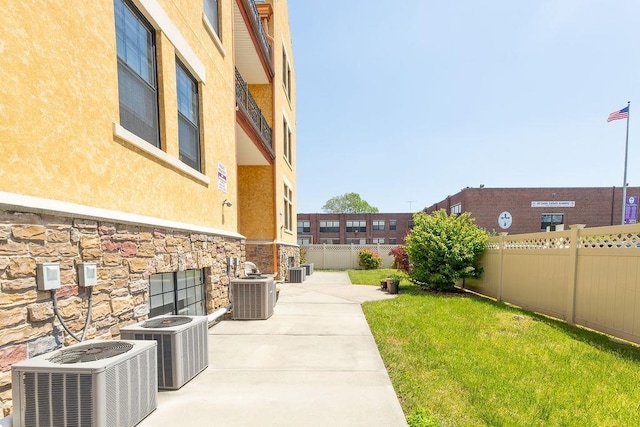 view of yard with a fenced backyard, a patio, and cooling unit