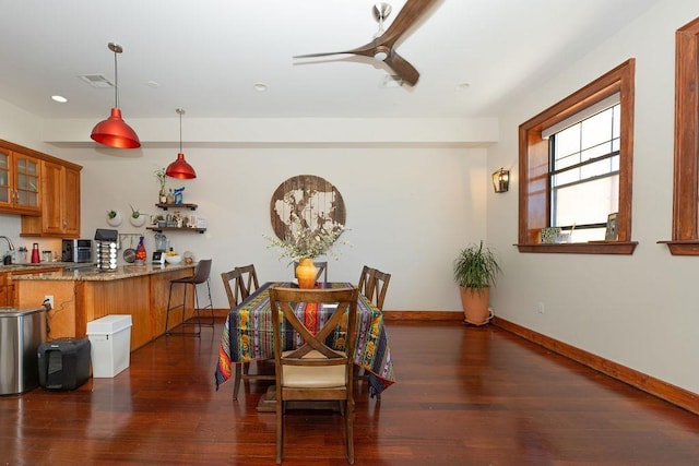dining room featuring baseboards, a ceiling fan, wood finished floors, and visible vents
