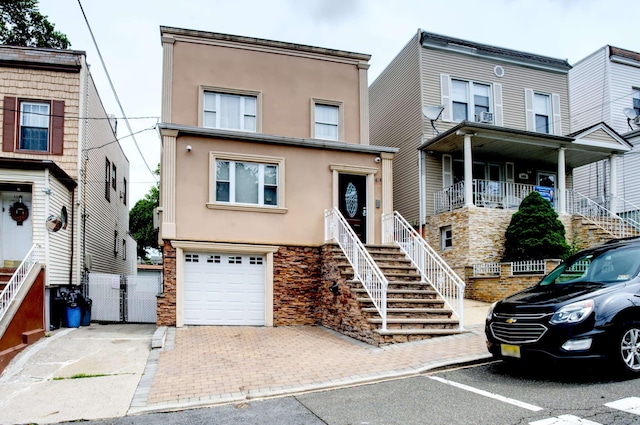 1404 81st St, North Bergen, NJ 07047 - townhome / multi-family property featuring stucco siding, stairway, a garage, and stone siding