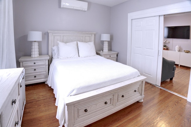 1404 81st St, North Bergen, NJ 07047 - bedroom featuring an AC wall unit, dark wood-type flooring, and a closet