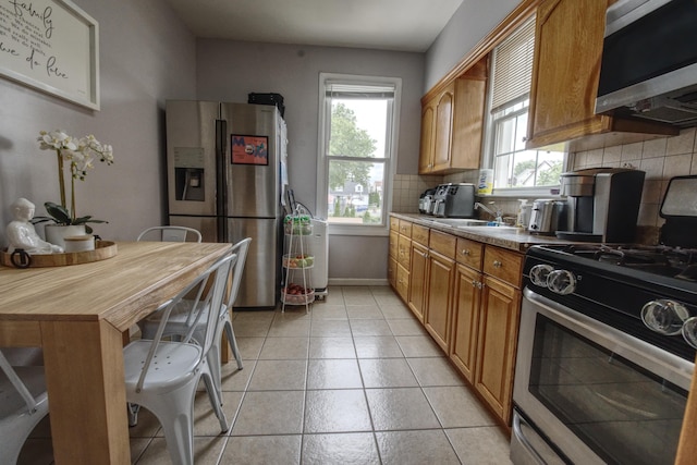 1404 81st St, North Bergen, NJ 07047 - kitchen featuring stainless steel appliances, tasteful backsplash, brown cabinetry, light tile patterned flooring, and a sink