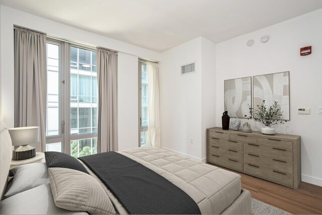 2 Shore Ln Unit 410, Jersey City, NJ 07310 - bedroom with multiple windows, wood finished floors, and access to outside
