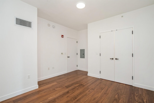 2 Shore Ln Unit 410, Jersey City, NJ 07310 - unfurnished bedroom featuring electric panel, wood finished floors, and a closet