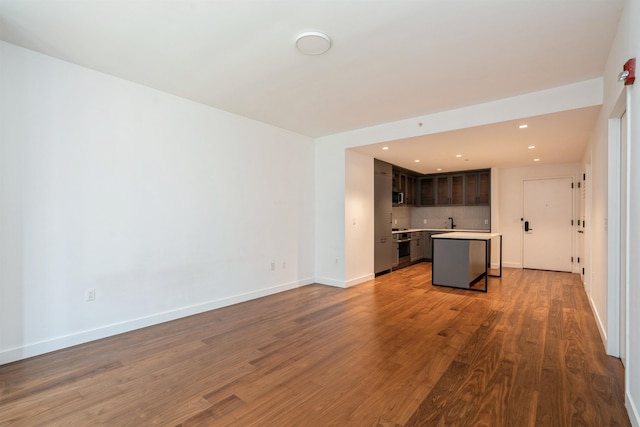 2 Shore Ln Unit 410, Jersey City, NJ 07310 - unfurnished living room featuring wood finished floors and recessed lighting