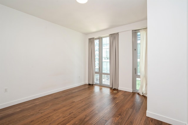 2 Shore Ln Unit 410, Jersey City, NJ 07310 - unfurnished room with dark wood-style flooring and baseboards