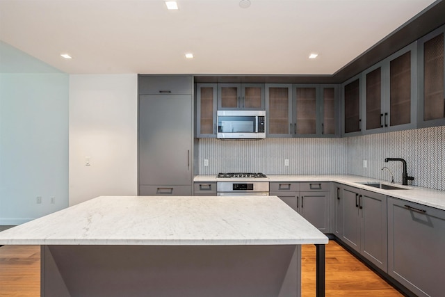 2 Shore Ln Unit 410, Jersey City, NJ 07310 - kitchen featuring stainless steel appliances, tasteful backsplash, light wood-style floors, a kitchen island, and recessed lighting
