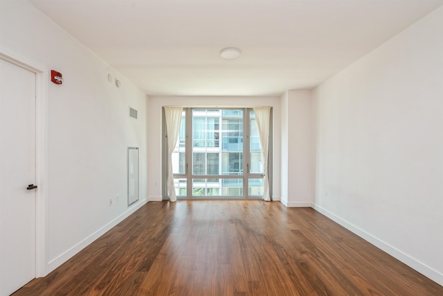 2 Shore Ln Unit 410, Jersey City, NJ 07310 - empty room featuring dark wood-style flooring and baseboards