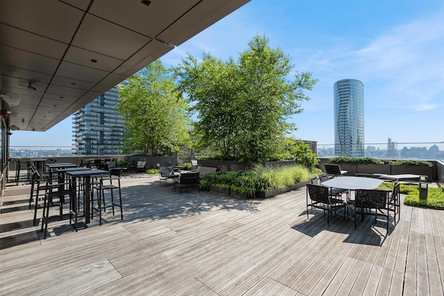 2 Shore Ln Unit 410, Jersey City, NJ 07310 - wooden terrace with outdoor dining space and a view of city