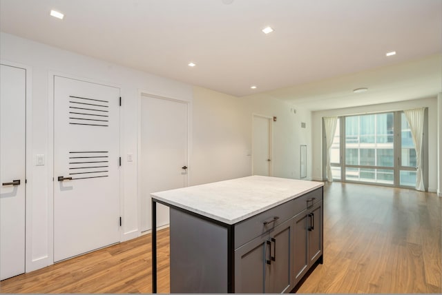 2 Shore Ln Unit 410, Jersey City, NJ 07310 - kitchen featuring gray cabinetry, light wood-type flooring, a center island, light countertops, and a breakfast bar