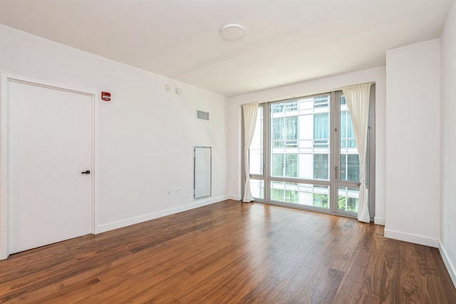 2 Shore Ln Unit 410, Jersey City, NJ 07310 - unfurnished room featuring wood finished floors and baseboards