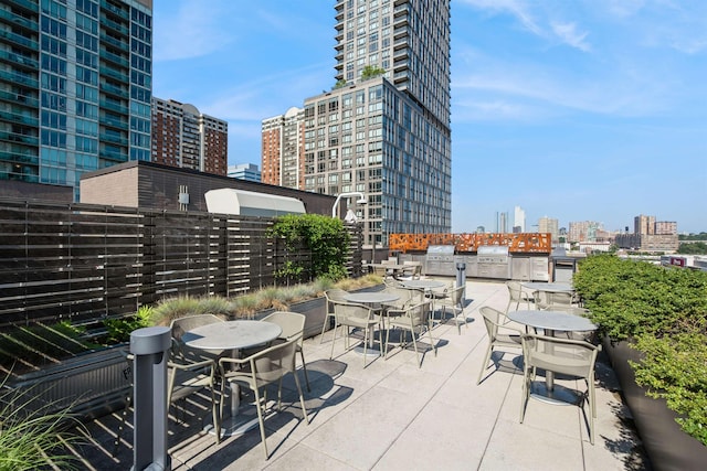 2 Shore Ln Unit 410, Jersey City, NJ 07310 - view of patio / terrace featuring outdoor dining area, a view of city, and area for grilling