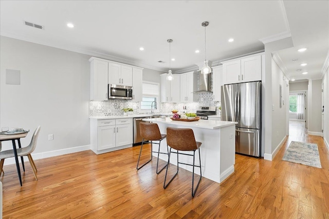 41 Graham St Unit 2, Jersey City, NJ 07307 - kitchen featuring appliances with stainless steel finishes, wall chimney exhaust hood, crown molding, tasteful backsplash, and plenty of natural light