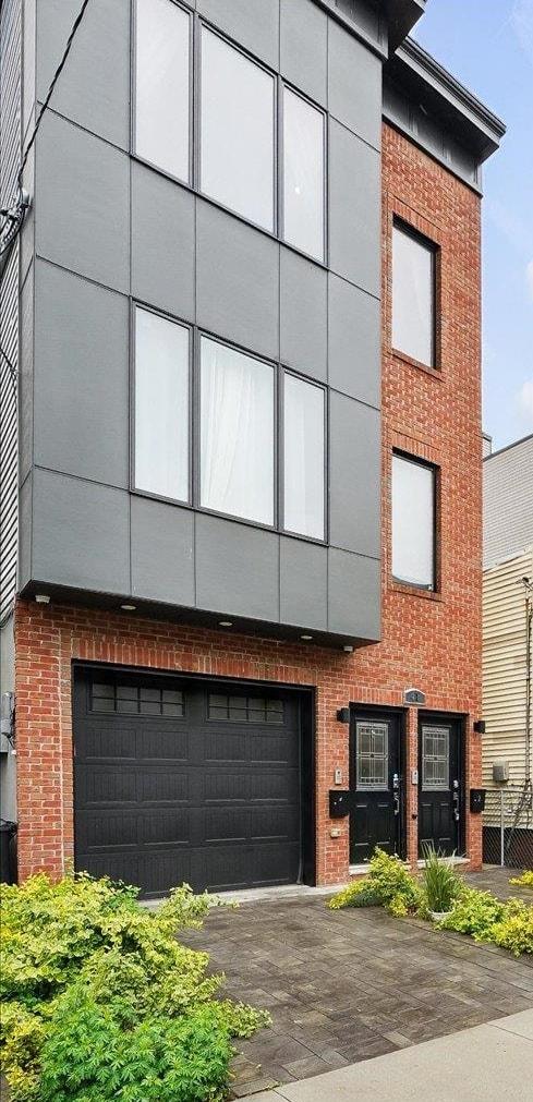 41 Graham St Unit 2, Jersey City, NJ 07307 - view of front of property with brick siding, a garage, and asphalt driveway