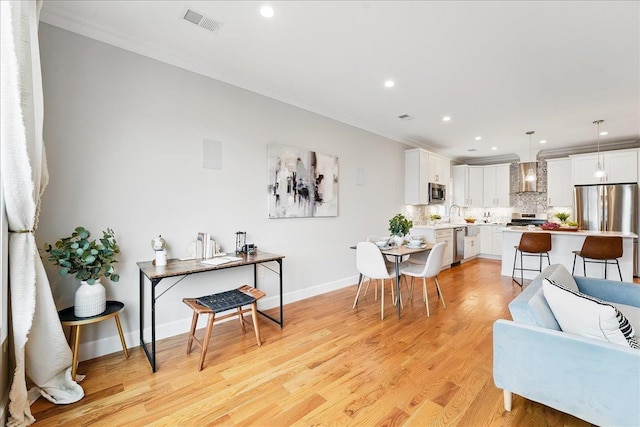 41 Graham St Unit 2, Jersey City, NJ 07307 - living area with ornamental molding, recessed lighting, light wood-style floors, and baseboards