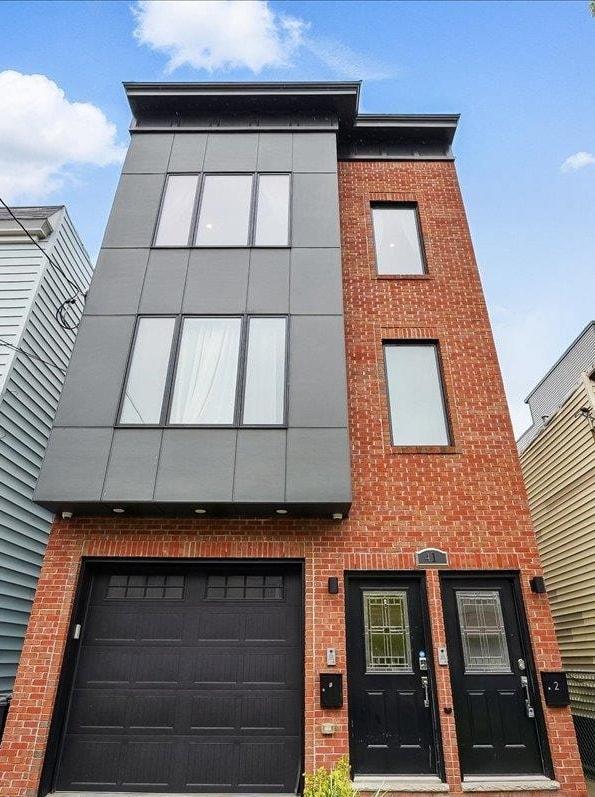 41 Graham St Unit 2, Jersey City, NJ 07307 - view of front of home with brick siding and a garage