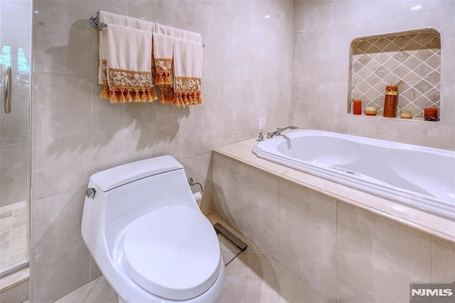 300 Gorge Rd # 18, Cliffside Park, NJ 07010 - bathroom with tile walls and a garden tub