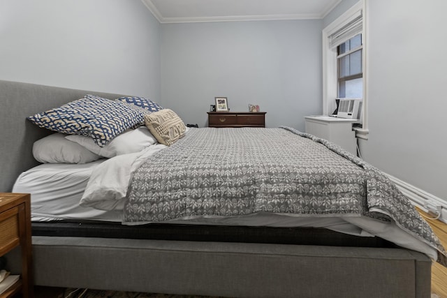 bedroom with crown molding, cooling unit, and wood finished floors