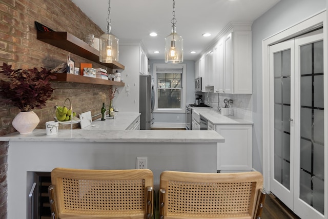 bar featuring pendant lighting, recessed lighting, decorative backsplash, and appliances with stainless steel finishes