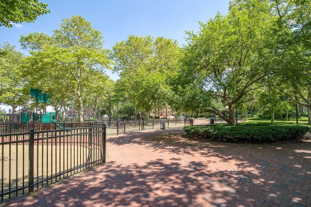 surrounding community with playground community and fence