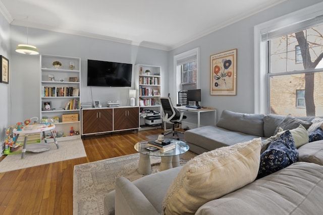 living room with crown molding, dark wood-style floors, a healthy amount of sunlight, and built in features