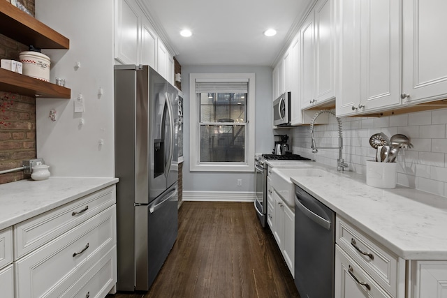 kitchen with white cabinetry, dark wood-style flooring, baseboards, backsplash, and appliances with stainless steel finishes