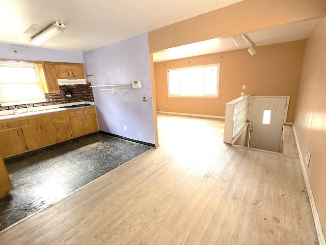 1437 Gehr Pl, North Bergen, NJ 07407 - kitchen featuring under cabinet range hood, stainless steel gas stovetop, dark wood finished floors, and tasteful backsplash