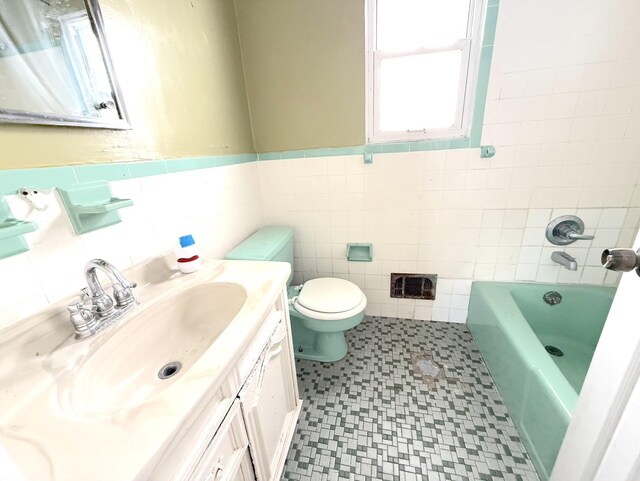 1437 Gehr Pl, North Bergen, NJ 07407 - bathroom with tile patterned floors, vanity, tile walls, and wainscoting