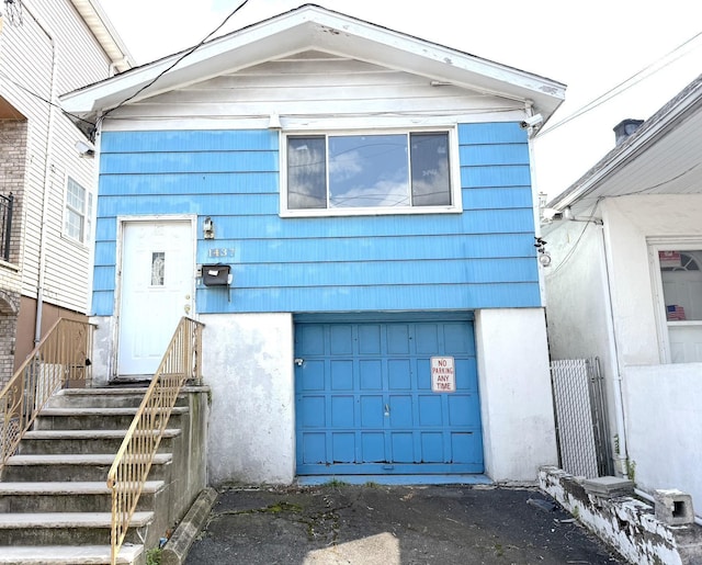 1437 Gehr Pl, North Bergen, NJ 07407 - view of front of home featuring a garage, asphalt driveway, and stucco siding