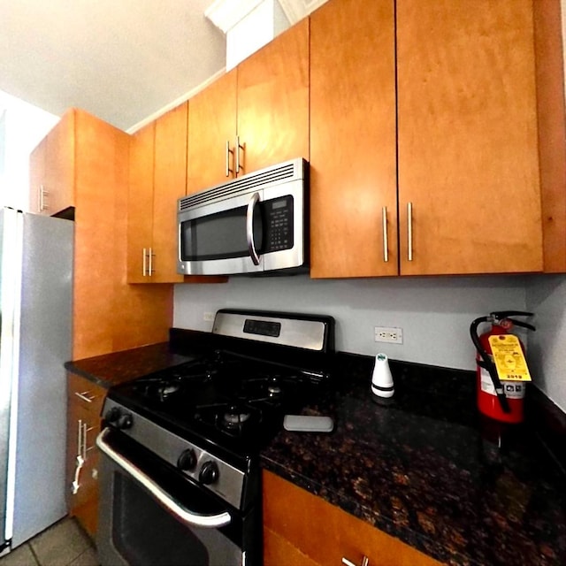 172 Culver Ave Unit 301, Jersey City, NJ 07305 - kitchen with appliances with stainless steel finishes, dark stone counters, and tile patterned flooring