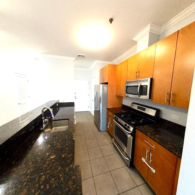 172 Culver Ave Unit 301, Jersey City, NJ 07305 - kitchen featuring appliances with stainless steel finishes, a sink, crown molding, tile patterned flooring, and dark stone countertops