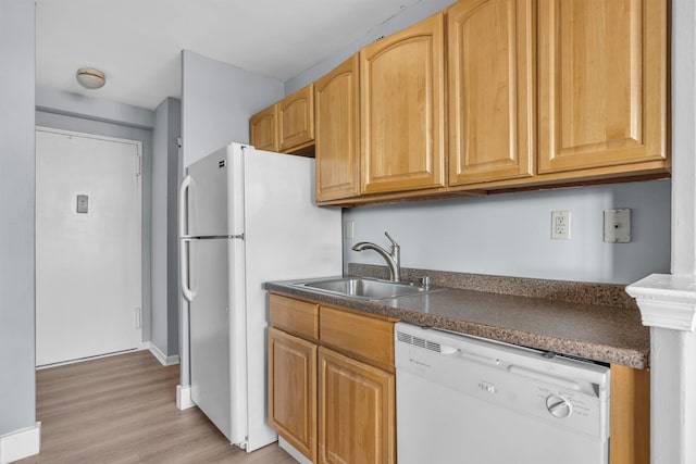 kitchen with sink, white appliances, and light hardwood / wood-style flooring