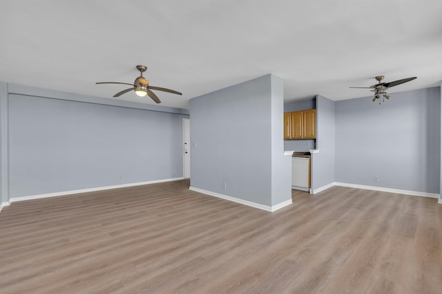 unfurnished living room featuring ceiling fan and light hardwood / wood-style flooring